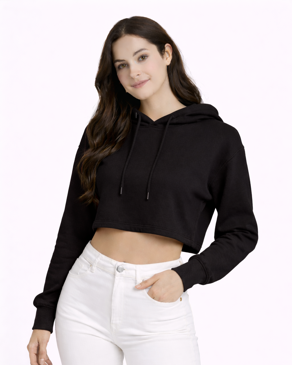 Woman wearing a black cropped hoodie and white pants on a white background