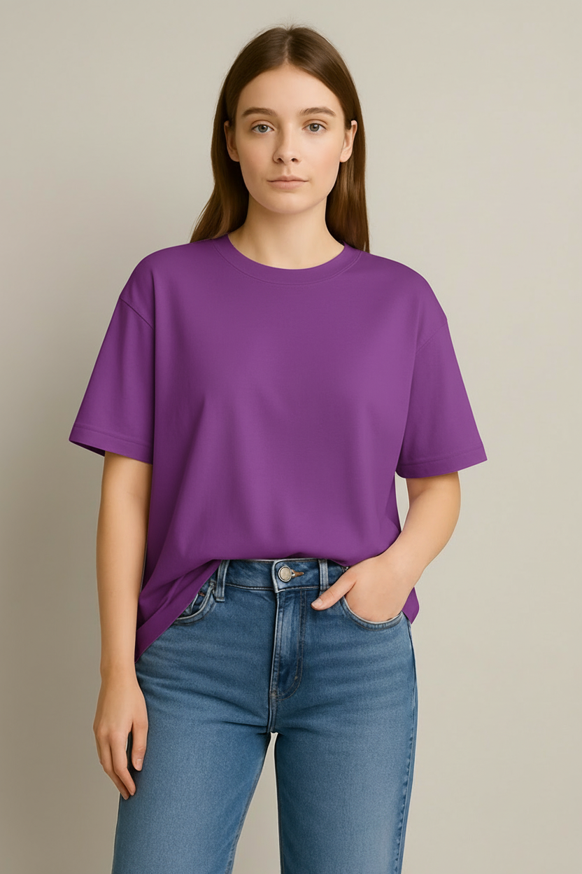Person wearing a light purple t-shirt and blue jeans against a neutral background