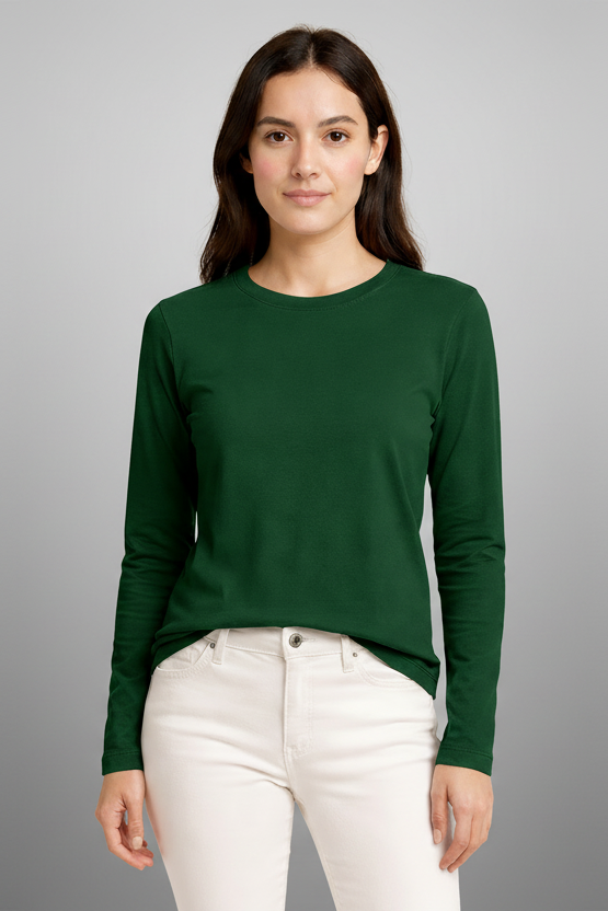 Woman wearing a green long-sleeve shirt and white pants on a beige background