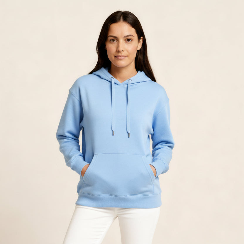 Woman wearing a blue hoodie on a beige background