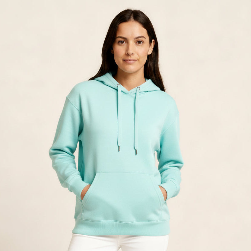 Woman wearing a blue hoodie on a beige background