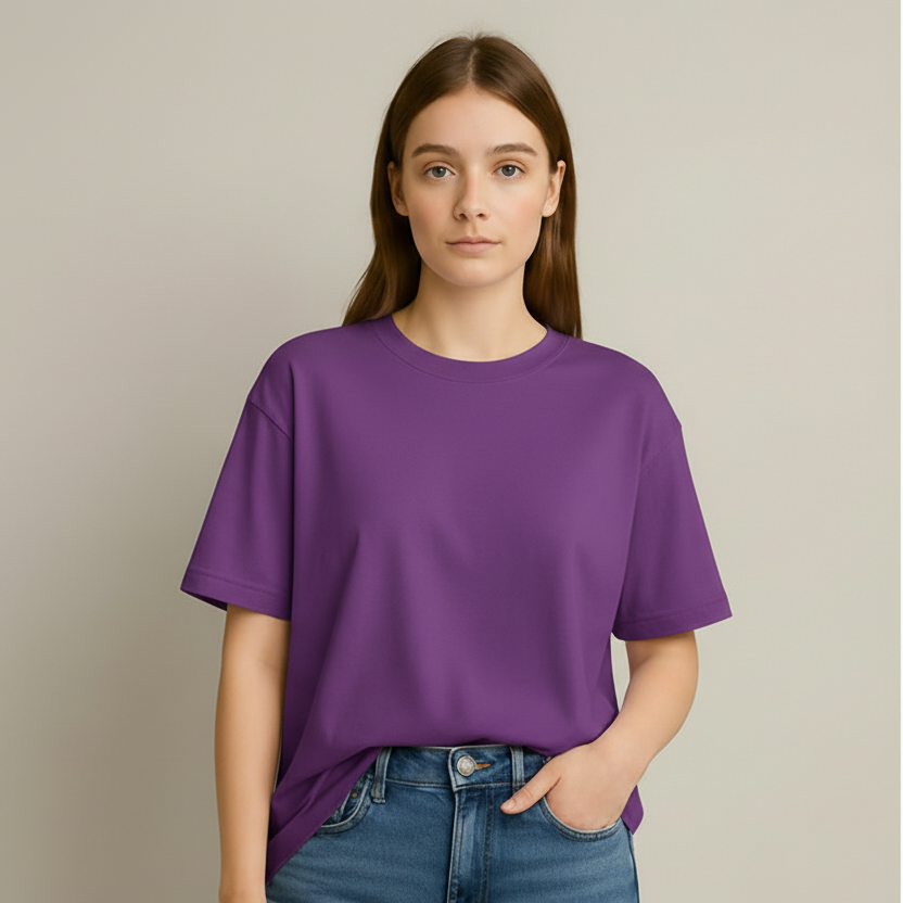 Person wearing a purple t-shirt and blue jeans against a neutral background